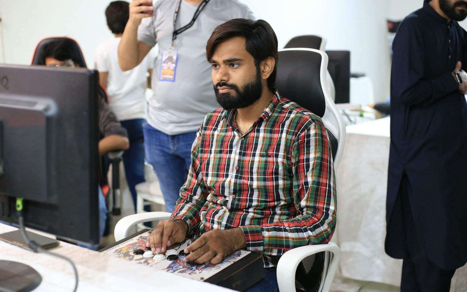 An Indian analyst reviewing data on a computer monitor in an office